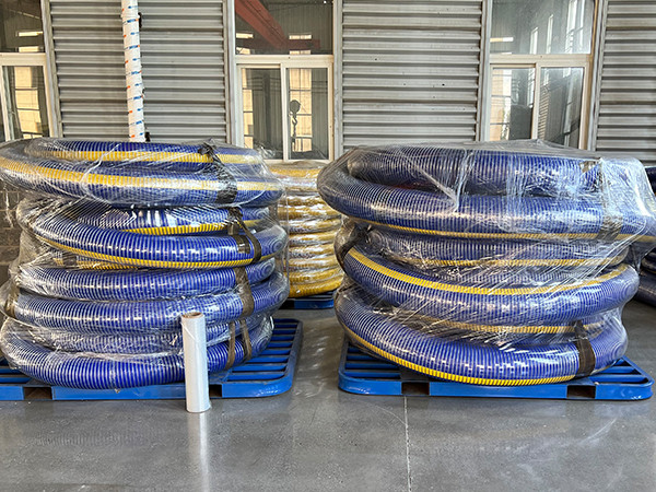 Packaged blue composite hose stacked on blue plastic rack