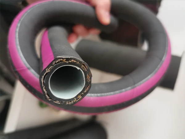 Cross-section of a black acid and alkali resistant rubber hose with a purple label