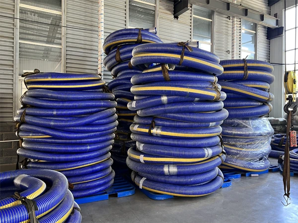 Blue flexible chemicals composite hose finished products stacked in the warehouse