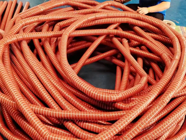 A small orange-yellow high temperature silicone duct hose