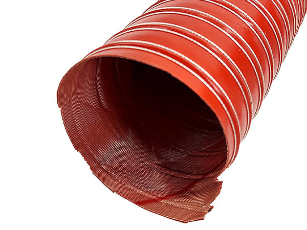 A red high temperature silicone duct hose placed on a flat surface