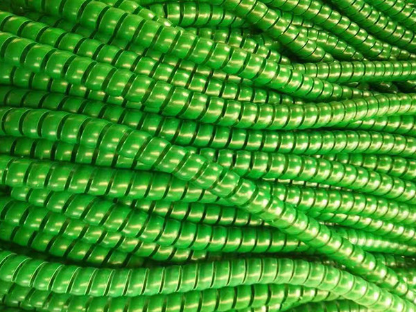 A green hydraulic hose plastic spiral protector