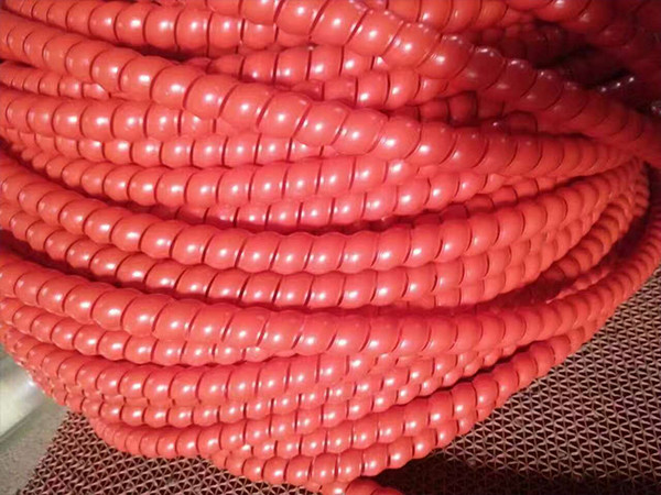 A set of red hydraulic hose plastic spiral protector