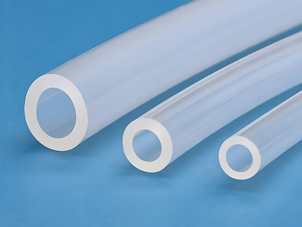 Two medical silicone hose on a green desktop.