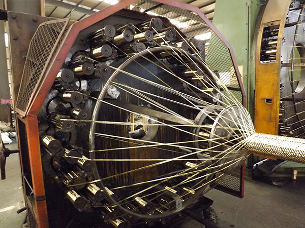 Reinforced yarn braiding machine in operation for processing steam rubber hose