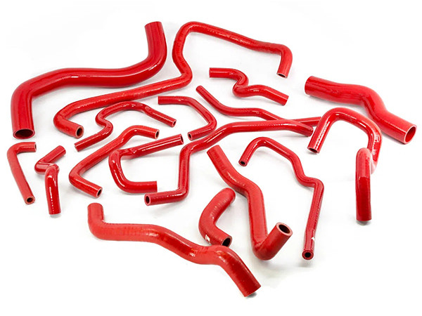 Red silicone hose car kits of different shapes and sizes on a white background